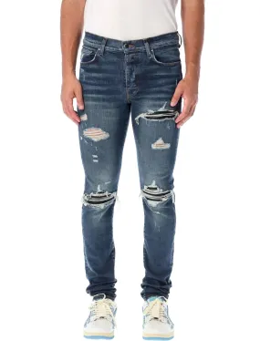 AMIRI MX1 DISTRESSED SKINNY LEG JEANS